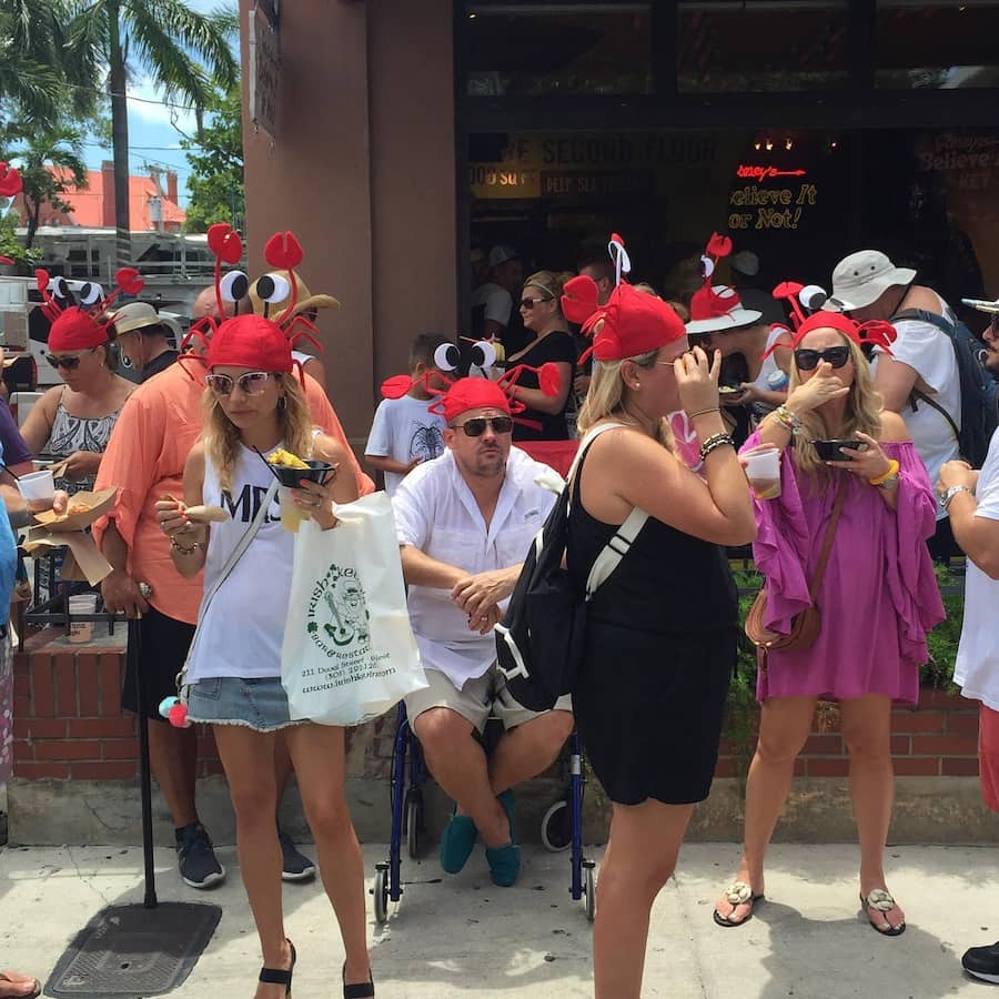 people eating crab with crab hats