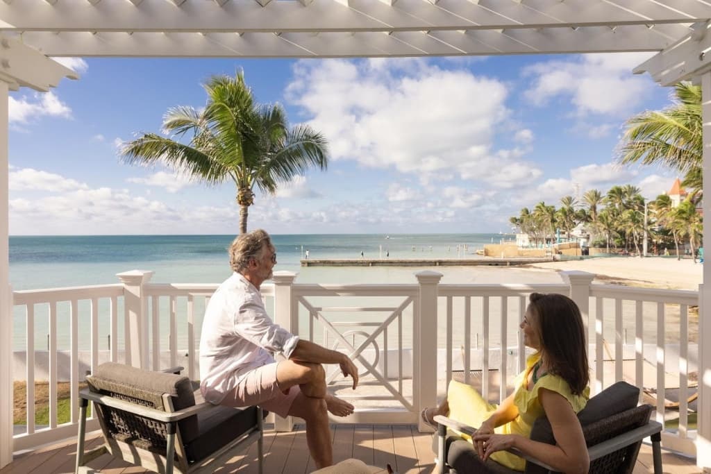 couple on balcony looking at beach