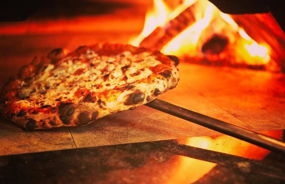 pizza coming out of the oven