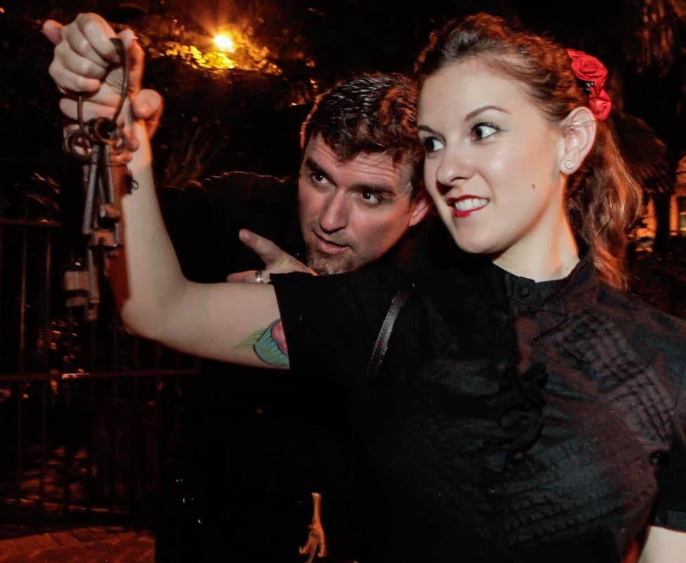 Man and woman hold up set of old-style keys while on a Haunted Key West Tour.