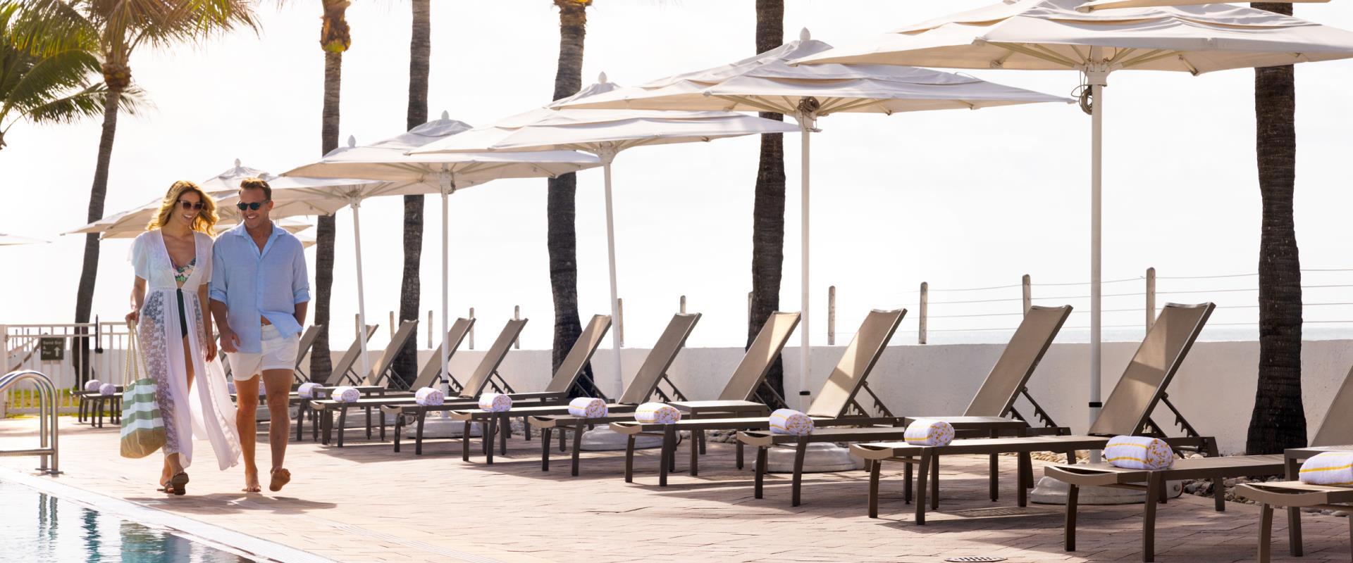 Couple Walking Along Shores Poolside