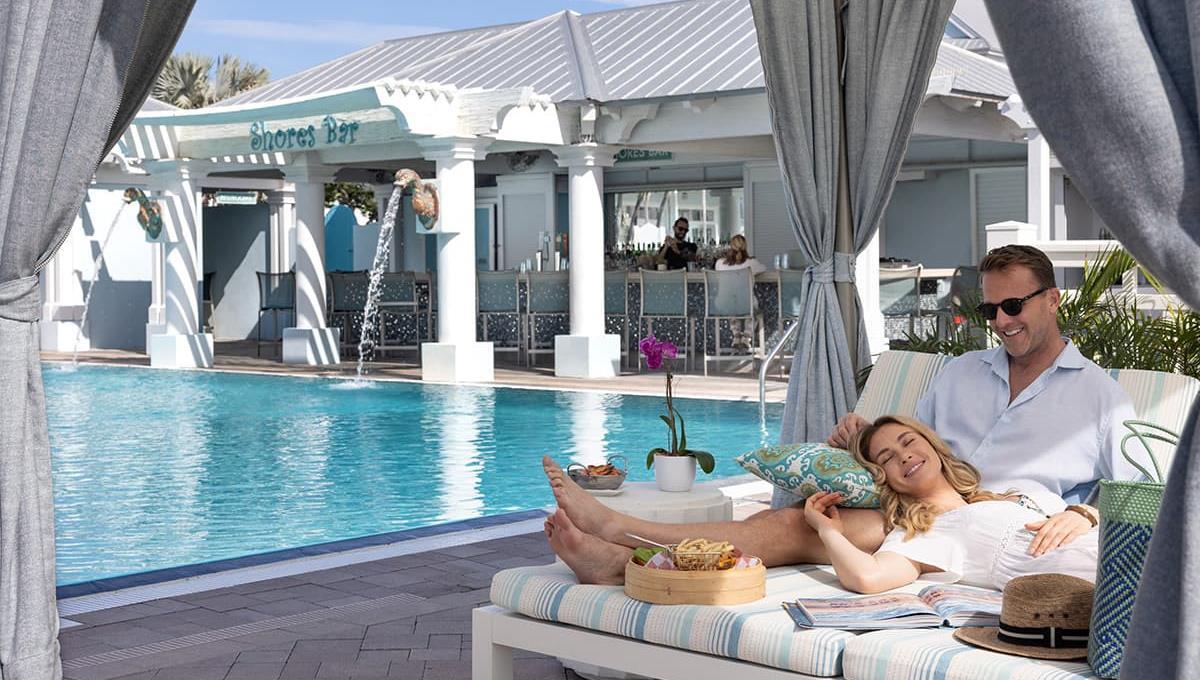 A couple in a cabana by the pool